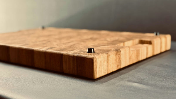 Wooden cutting board shown from the side to reveal its thickness