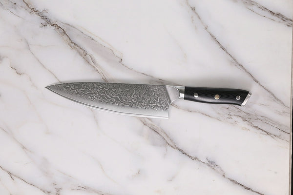 Kitchen knife resting directly on a marble countertop