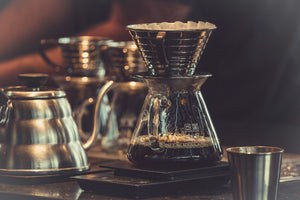 Pour-over coffee draining through a glass brewer