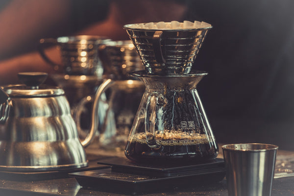 Pour-over coffee draining through a glass brewer