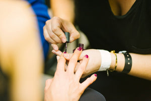 A manicure being performed with nail-care tools