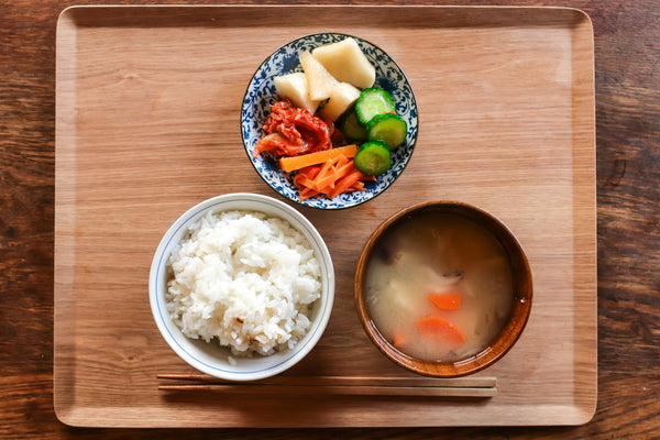 Japanese meal served as several bowls and dishes on a tray