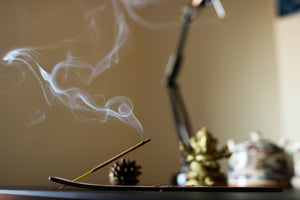 Incense burning with a thin trail of smoke