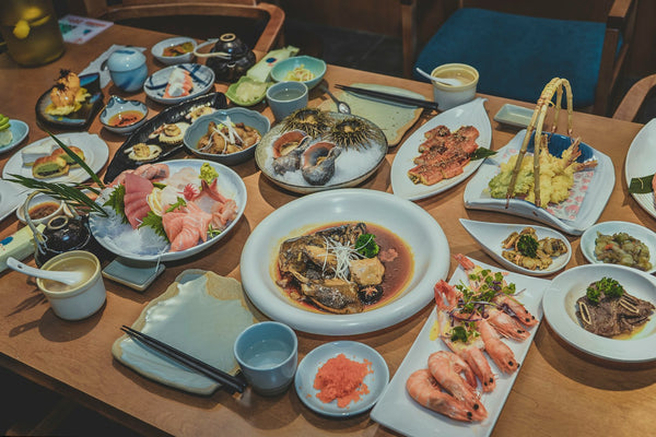 Japanese meal with several dishes arranged on a wooden table