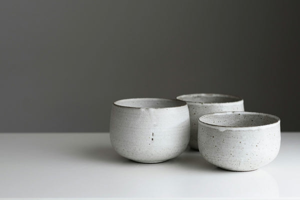 Handmade pale-glazed ceramic bowls illustrating the tactile qualities of Japanese tea ceramics