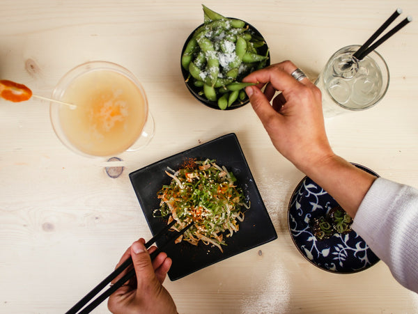 Diner eating Japanese food with chopsticks