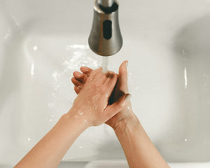 Bare feet resting in a white bathtub