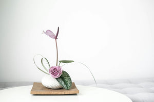 Minimal ikebana flower arrangement in a ceramic vessel