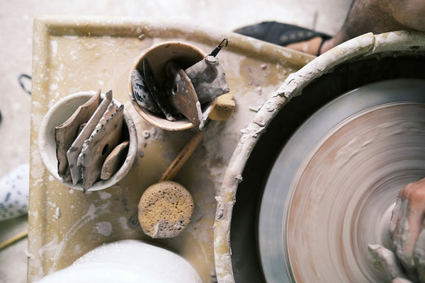 Clay being shaped on a pottery wheel as a clay-working reference; not a verified Mentori furo