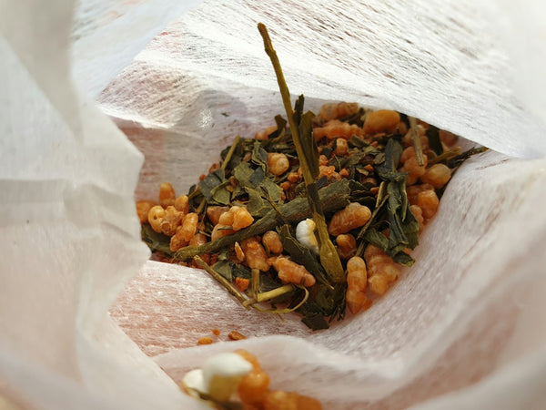 Green tea and roasted rice blend in a white ceramic bowl