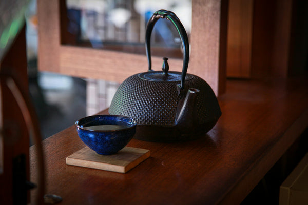 Dark iron Japanese tea ware illustrating the late-furo material atmosphere associated with nimonji kakiage