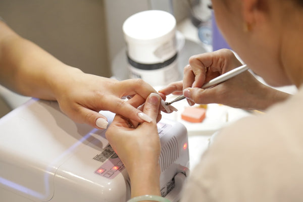 A close-up of nail care being performed