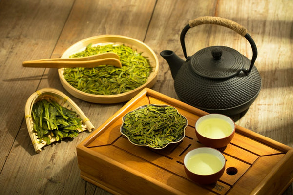 Tea set with a teapot and two cups of green tea