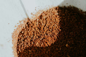 Fresh coffee grounds and beans after grinding