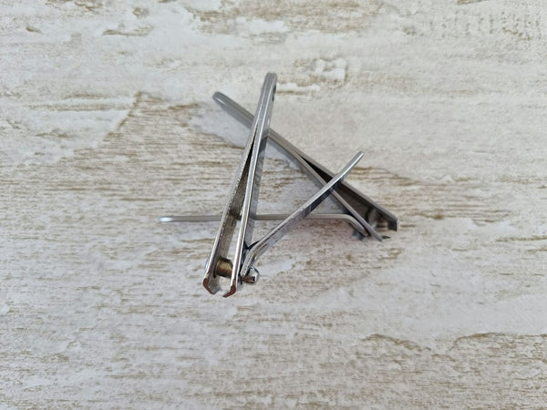 A precision metal cutting tool resting on a wooden surface