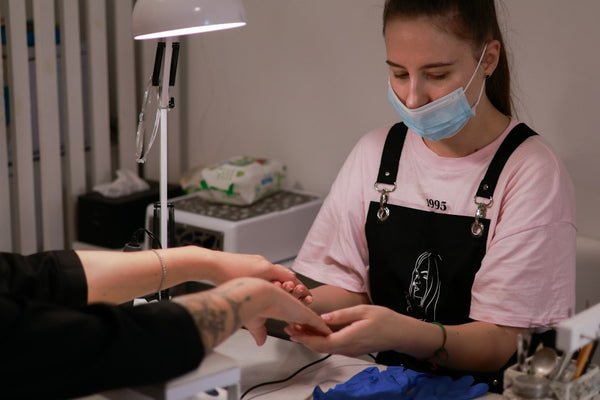 A manicure being performed on a natural fingernail