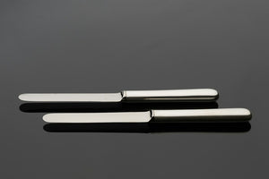 A close-up of stainless steel cutting scissors on a table