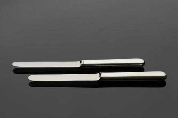 A close-up of stainless steel cutting scissors on a table