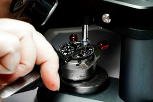 Close-up precision work on a small metal mechanism