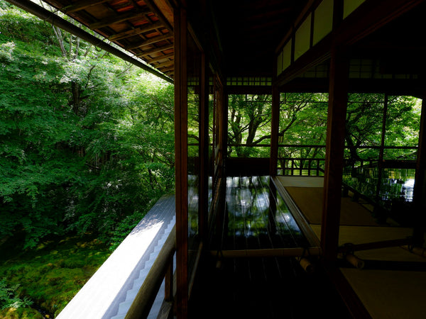 Traditional Kyoto interior with wood framing and a garden view illustrating natural-material Japanese architecture