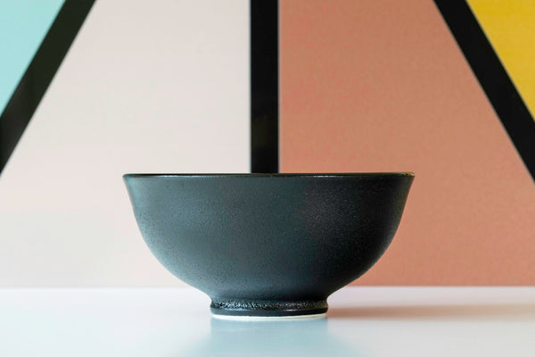 Black glazed ceramic bowl illustrating the concentrated dark surface associated with black tea ceramics