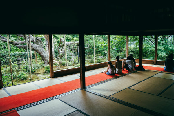 Guests seated in a traditional Japanese room overlooking a garden
