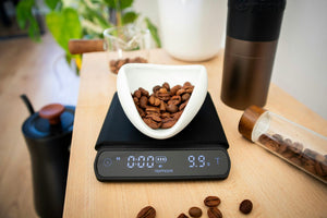 Coffee beans being weighed on a digital scale