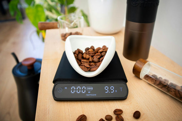 Coffee beans being weighed on a digital scale