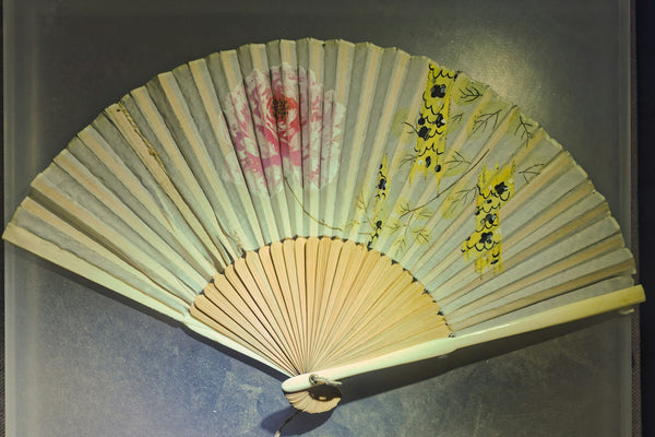 Japanese-style folding fan with floral decoration, illustrating the compact sensu form used as a guest utensil in chanoyu