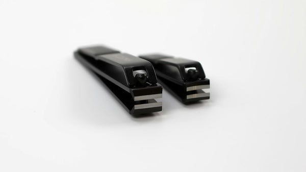 Two nail clippers on a white background