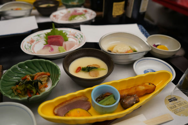 Japanese meal arranged in multiple bowls and small dishes
