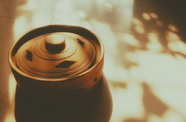 Small lidded ceramic vessel in warm light