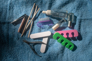 Manicure and pedicure tools arranged on a clean towel