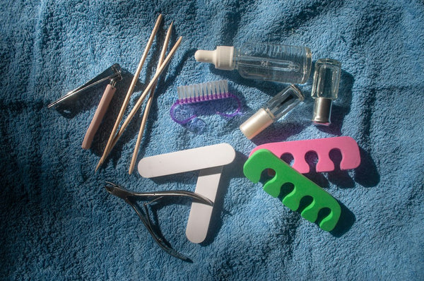 Manicure and pedicure tools arranged on a clean towel