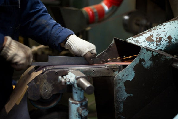Knife blade being ground in a Japanese knife workshop