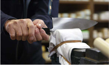 Knife finishing by hand in a Japanese knife workshop